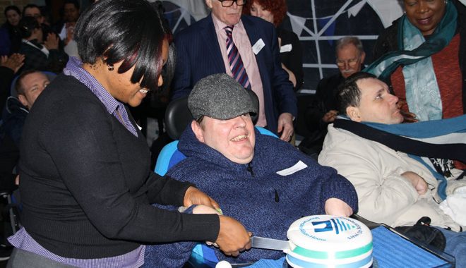 Royston cutting the cake for the 40th Anniversary of Alison House